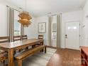 Bright dining room with hardwood floors, stylish lighting, and seating for six at 1921 Union St, Charlotte, NC 28205