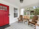 Inviting front porch featuring chairs and a bright red door at 1921 Union St, Charlotte, NC 28205