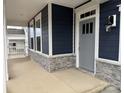 Stylish front porch featuring stone accents and a gray front door at 2036 Skyhawk Dr, York, SC 29745