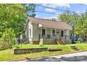 Adorable single-Gathering home with a well-kept lawn, charming front porch, and traditional siding at 225 Institute St, Mooresville, NC 28115