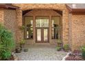 Elegant brick entryway with a double front door, flanked by decorative plants and stone accents at 225 Riverton Rd, Weddington, NC 28104