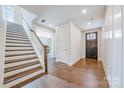 Bright foyer with hardwood floors, white trim, and staircase leading to the upper level at 3288 Sherman Dr, Lancaster, SC 29720