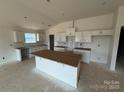 Unfinished kitchen featuring white cabinets and an island ready for customization to your needs at 338 Knotty Wood Dr # 69, Monroe, NC 28110