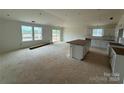 Bright kitchen with ample space features an island and white cabinetry, ready for customization at 338 Knotty Wood Dr # 69, Monroe, NC 28110