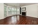 Spacious living room with hardwood flooring, fireplace, and large windows offering natural light at 521 N Graham St # 2B, Charlotte, NC 28202