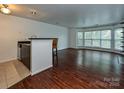 Open living space with hardwood floors, bar area, and bright bay windows at 521 N Graham St # 2B, Charlotte, NC 28202