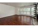 Well-lit living room showcasing hardwood floors, fireplace, and bright bay windows at 521 N Graham St # 2B, Charlotte, NC 28202