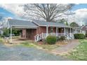 Charming single-story brick home with carport, front porch, and landscaped walkway at 816 S Point Rd, Belmont, NC 28012