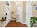 Elegant foyer with hardwood floors, white doors, and a staircase at 8409 Scotney Bluff Ave, Charlotte, NC 28273