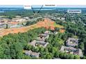 Aerial shot of a lakeside residential neighborhood featuring lush trees and close proximity to businesses and a lake at 8925 Rosalyn Glen Rd, Cornelius, NC 28031