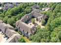 An aerial view showcases a unique courtyard design, nestled amongst lush green trees and manicured landscaping at 8925 Rosalyn Glen Rd, Cornelius, NC 28031