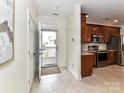 Open entryway with a view to the outside, leading into a kitchen with stainless steel appliances at 8925 Rosalyn Glen Rd, Cornelius, NC 28031