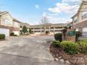 Condo building with brick accents, garages, manicured landscaping and address displayed at 8925 Rosalyn Glen Rd, Cornelius, NC 28031