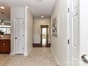Inviting hallway with tile flooring and a view into other rooms of the home at 8925 Rosalyn Glen Rd, Cornelius, NC 28031