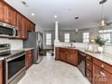Open concept kitchen with stainless steel appliances, granite counters, and tile backsplash at 8925 Rosalyn Glen Rd, Cornelius, NC 28031