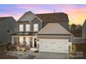 Charming two-story home with a well-maintained lawn and an attached two-car garage at 111 Old Field Rd, Statesville, NC 28677