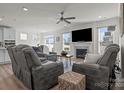 Bright and airy living room featuring a fireplace and ceiling fan at 111 Old Field Rd, Statesville, NC 28677