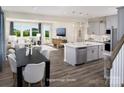 Bright, open-concept kitchen featuring a spacious island with pendant lighting and seamless flow to the living area at 12233 Gambrell Dr, Charlotte, NC 28278