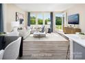 Airy living room with modern furnishings, large windows, and access to an outdoor patio, ideal for relaxation at 12233 Gambrell Dr, Charlotte, NC 28278