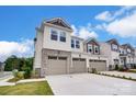 Townhome with a three-car garage and professionally landscaped front yard at 12241 Gambrell Dr, Charlotte, NC 28278