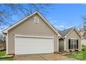 A well maintained exterior view featuring a two-car garage, vinyl siding, and manicured lawn at 1254 Autumn Breeze Ct, Rock Hill, SC 29732