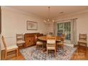 Traditional dining room with a round wooden table, six chairs, and a decorative rug beneath a chandelier at 12606 Bradford Hill Ln, Huntersville, NC 28078