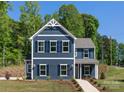Attractive new construction home with navy siding, white trim, shutters, and a welcoming walkway at 1402 Richmond Dr # 1, Lowell, NC 28098