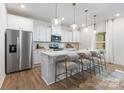 Bright and airy kitchen with a large center island, stainless steel appliances, and modern pendant lighting at 1402 Richmond Dr # 1, Lowell, NC 28098