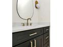 Stylish bathroom vanity with dark wood cabinets, gold hardware, and a white countertop and backsplash at 1508 Oak St, Charlotte, NC 28269