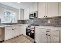 Updated kitchen with stainless steel oven, microwave, tile backsplash and ample counter space at 1522 Wickham Ln, Charlotte, NC 28208