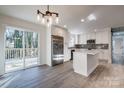 Bright kitchen with white cabinets, stainless steel appliances, and sliding doors to a deck at 1522 Wickham Ln, Charlotte, NC 28208