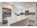 A beautifully updated kitchen features new stainless steel appliances and a large island at 1522 Wickham Ln, Charlotte, NC 28208