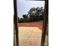 View of leveled backyard from new wood deck showcases potential for outdoor living at 2526 Elkwood Cir, Charlotte, NC 28205