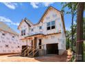 New home under construction with covered entryway, visible window frames, and unfinished siding at 2526 Elkwood Cir, Charlotte, NC 28205
