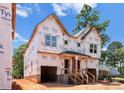 New two-story home with unfinished siding shows large front-facing windows and dual covered entries at 2526 Elkwood Cir, Charlotte, NC 28205