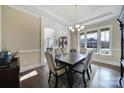 Formal dining room with a dark wood table, upholstered chairs, and a view to the front entryway at 400 Eden Hollow Ln, Weddington, NC 28104
