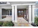 Inviting front entrance featuring double doors with decorative wreaths and stone flooring at 400 Eden Hollow Ln, Weddington, NC 28104