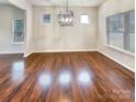 Dining room with a modern chandelier and ample natural light at 508 Stone River Pkwy, Mount Holly, NC 28120