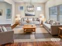 Bright living room with a neutral color palette, plush seating, and stylish decor at 508 Stone River Pkwy, Mount Holly, NC 28120