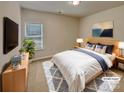 Cozy bedroom featuring a comfortable bed, soft lighting, and stylish decor at 508 Stone River Pkwy, Mount Holly, NC 28120