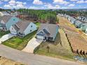 Aerial view of a modern home with well-maintained lawn in a neighborhood surrounded by trees and other houses at 5239 Admirals Lndg, Lancaster, SC 29720