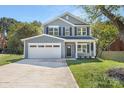 Beautifully built two-story home with a front-facing two car garage and driveway on a manicured lawn at 8465 Old Plank Rd, Charlotte, NC 28216