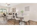 Comfortable living room combined with dining area, featuring neutral tones, stylish furnishings and bright natural light at 8465 Old Plank Rd, Charlotte, NC 28216