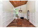 Bright dining room with decorative wainscoting and backyard views at 10213 Conistan Pl, Cornelius, NC 28031