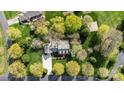 Aerial view of a home surrounded by lush greenery and mature trees at 1207 Chadbourne Ave, Concord, NC 28027