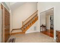 Bright foyer showcasing tile flooring, a wooden staircase, and an open doorway leading to the living spaces at 125 Cherokee Dr, Mooresville, NC 28117