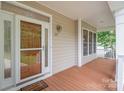 Inviting front porch featuring wood flooring, bright windows, and a welcoming door with decorative glass at 125 Cherokee Dr, Mooresville, NC 28117