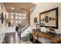 Elegant foyer with dark hardwood floors, ornate console table and decorative mirror at 15309 Guthrie Dr, Huntersville, NC 28078