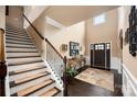 Inviting foyer featuring hardwood floors, elegant staircase, and high ceilings at 15309 Guthrie Dr, Huntersville, NC 28078