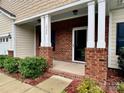 Inviting front porch with brick support columns with direct access to the main entrance of the house at 1726 Still River Way, Fort Mill, SC 29708